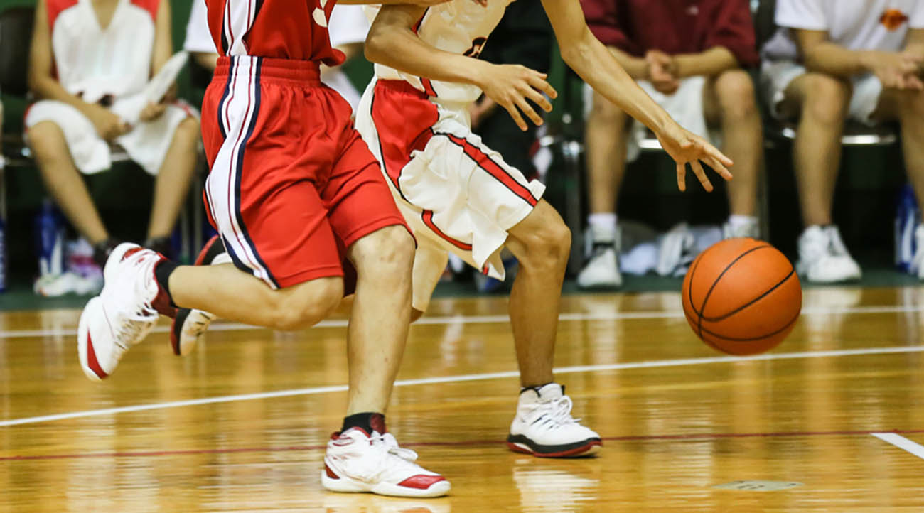 Basketball players feet chasing and basketball