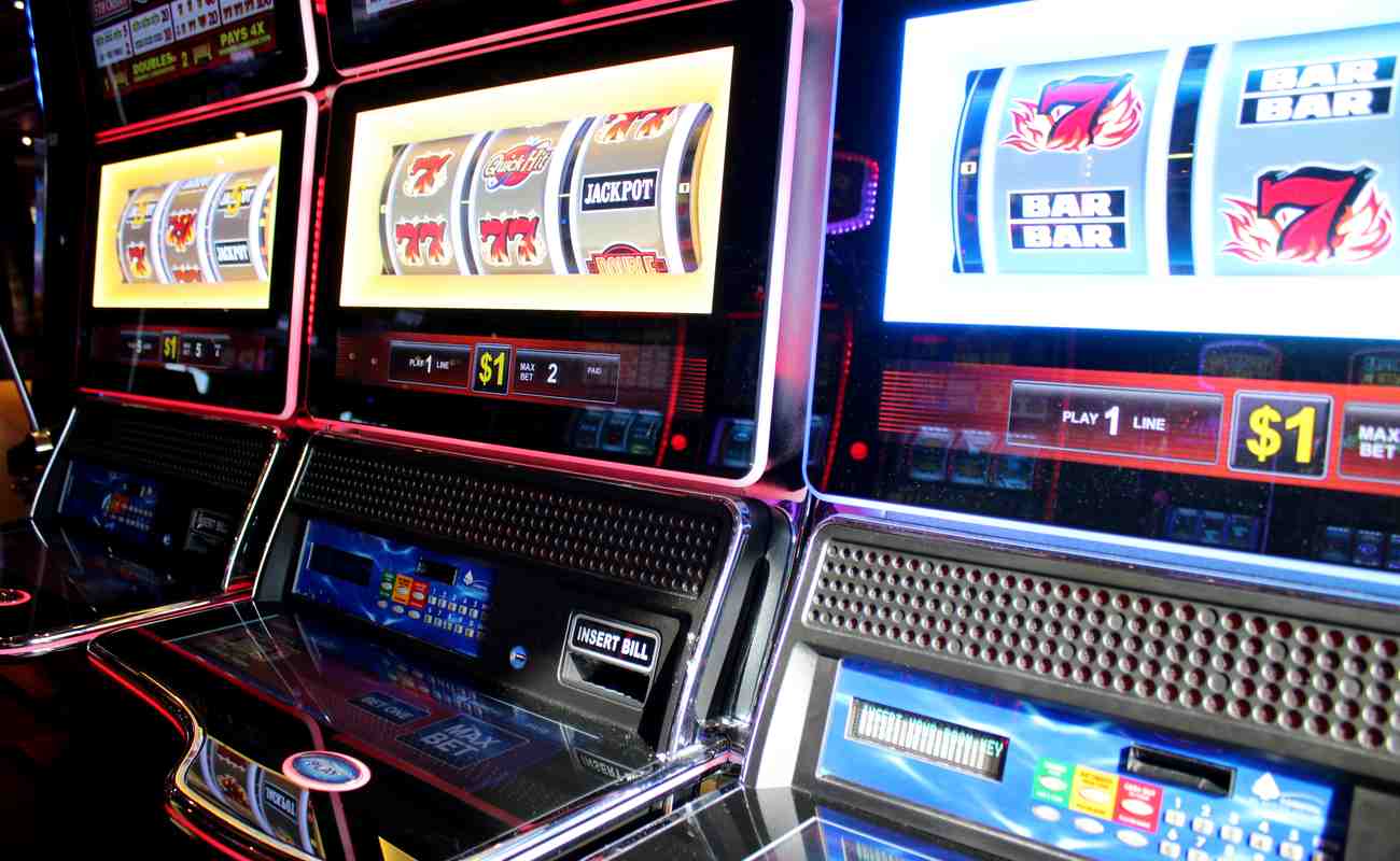 3 casino slot machines, each displaying different jackpot and number combinations on reels.