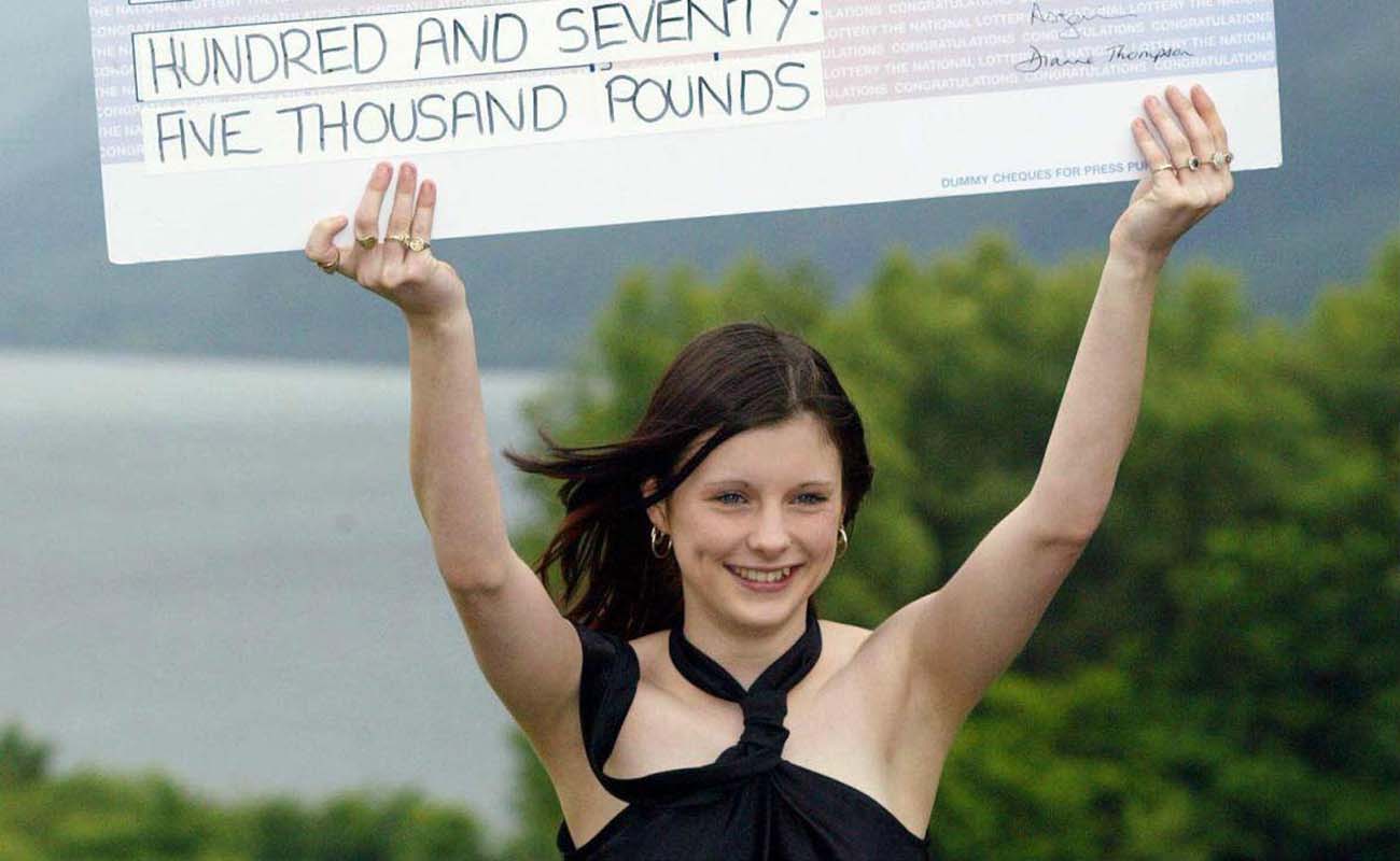 Callie Rogers holding a cheque