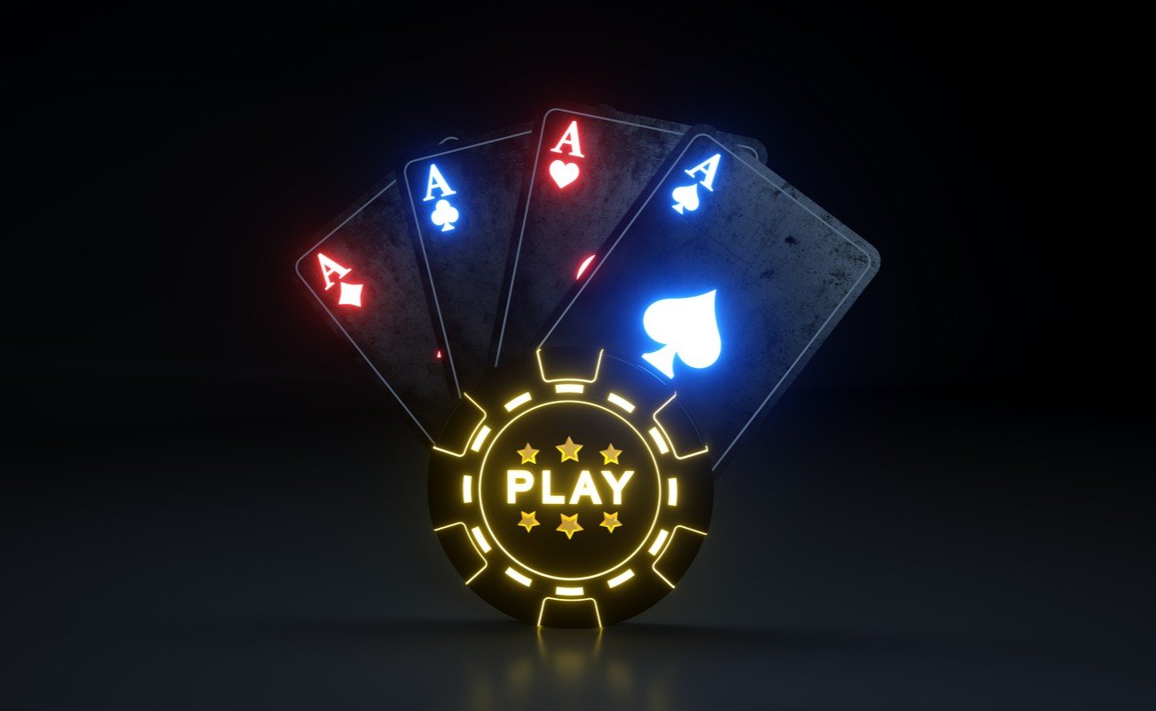 Lit up gaming chip with the word play on it with lit up hand of aces
