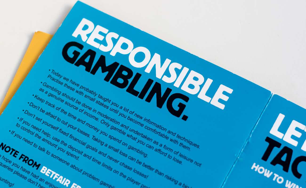 A Blue Responsible Gambling Pamphlet on a White Background