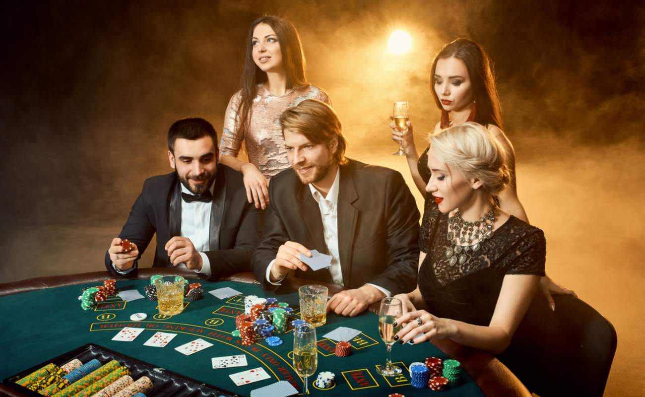 Players drinking and enjoying themselves at a casino table.