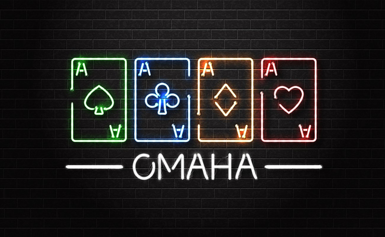 The word ‘Omaha’ and four aces lit up in neon lights on a wall.
