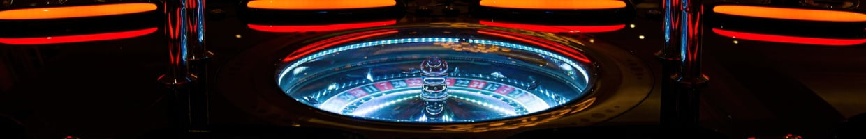 Roulette table at a casino lit up at night