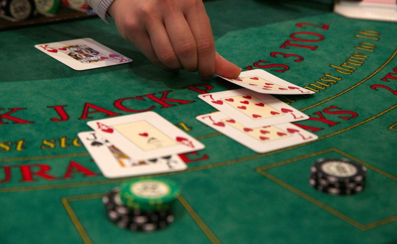 Dealer placing cards down on blackjack table