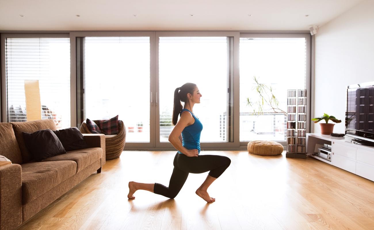 A girl exercising in her apartment.