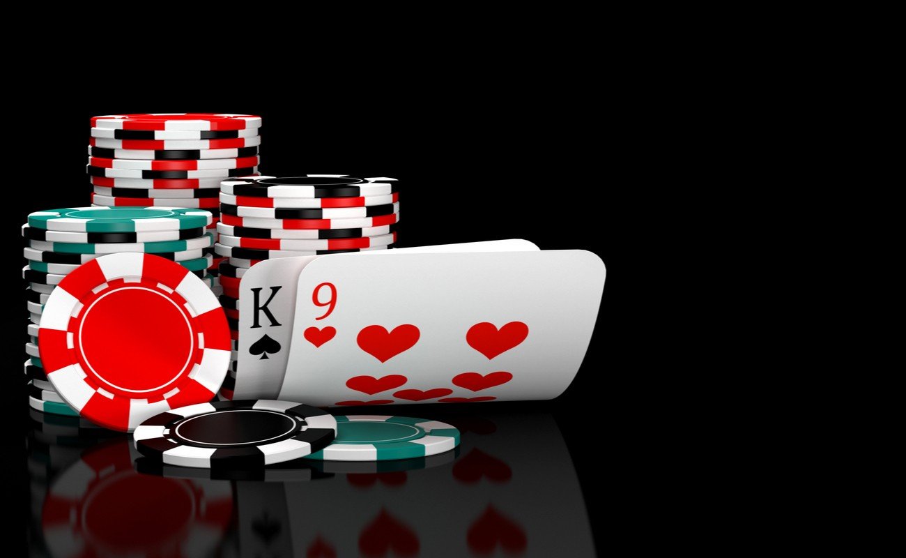 Baccarat cards and casino chips against a black background.