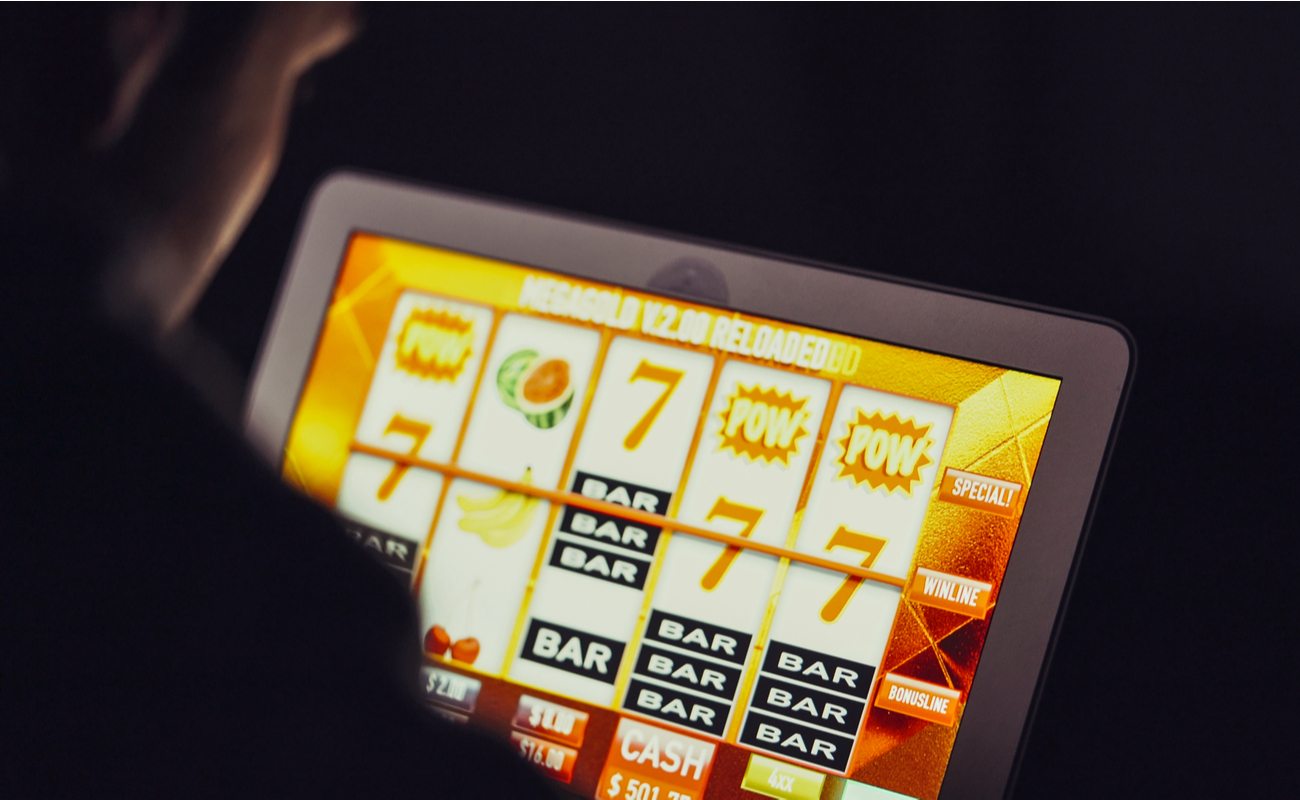 Man playing an online slot on a tablet device.