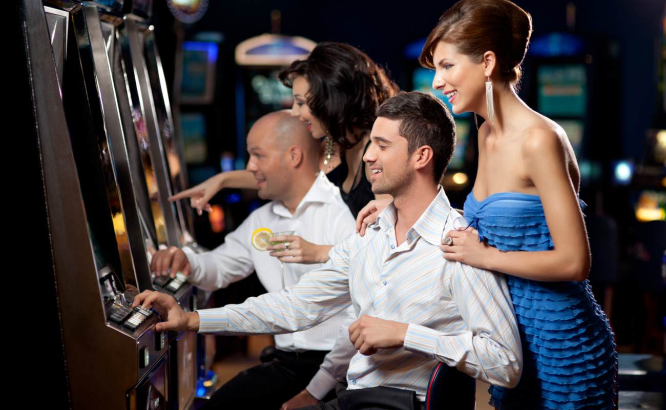 Two couples have a good time playing slots.