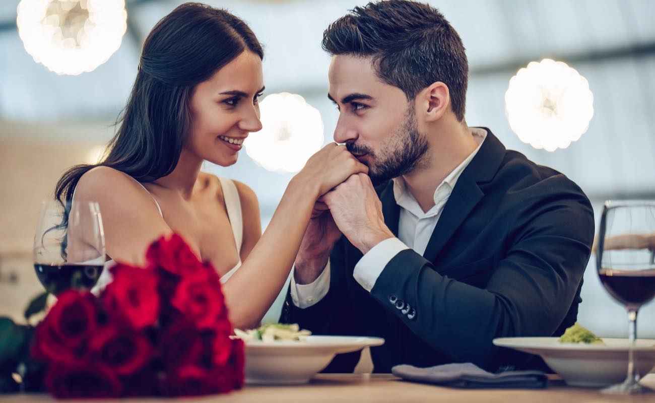 Couple at a romantic dinner looking into each other's eyes.