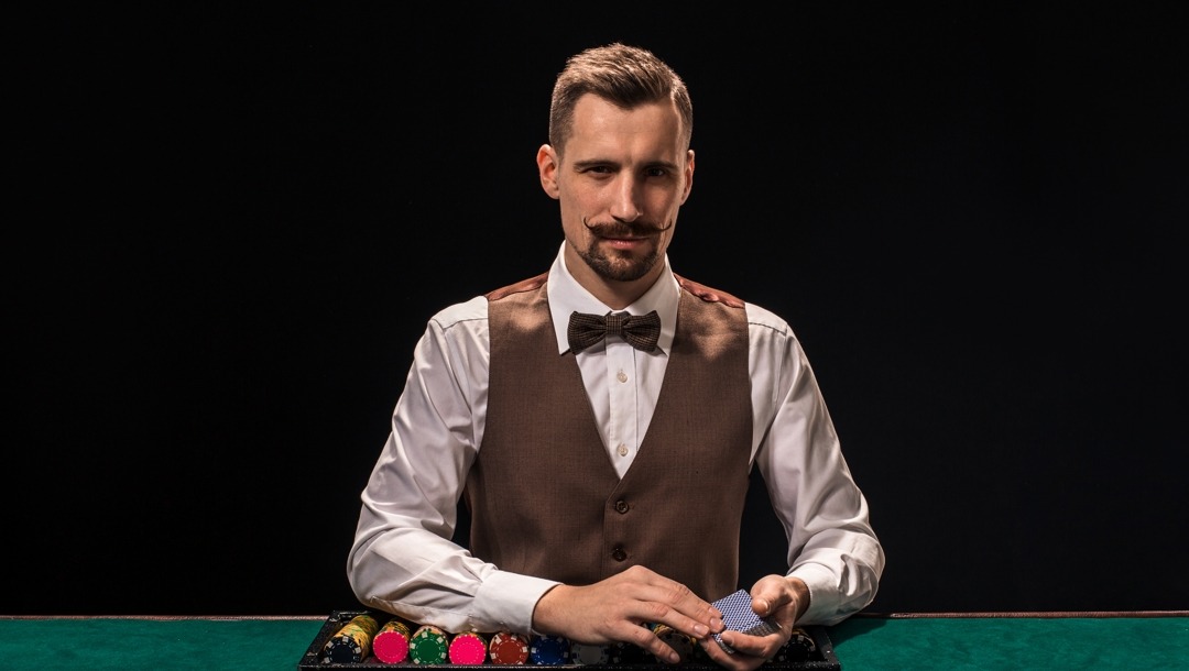 https://casino.betmgm.com/en/blog/wp-content/uploads/2023/03/Header-A-well-dressed-dealer-about-to-deal-cards-First-time-poker.jpg