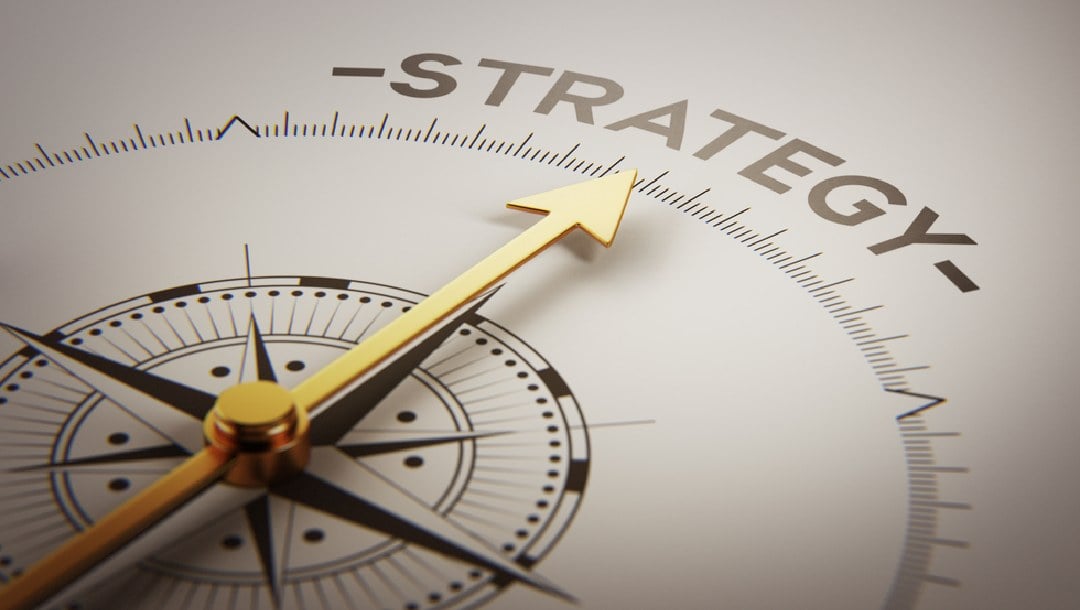 A compass arrow pointing to the word “strategy.”