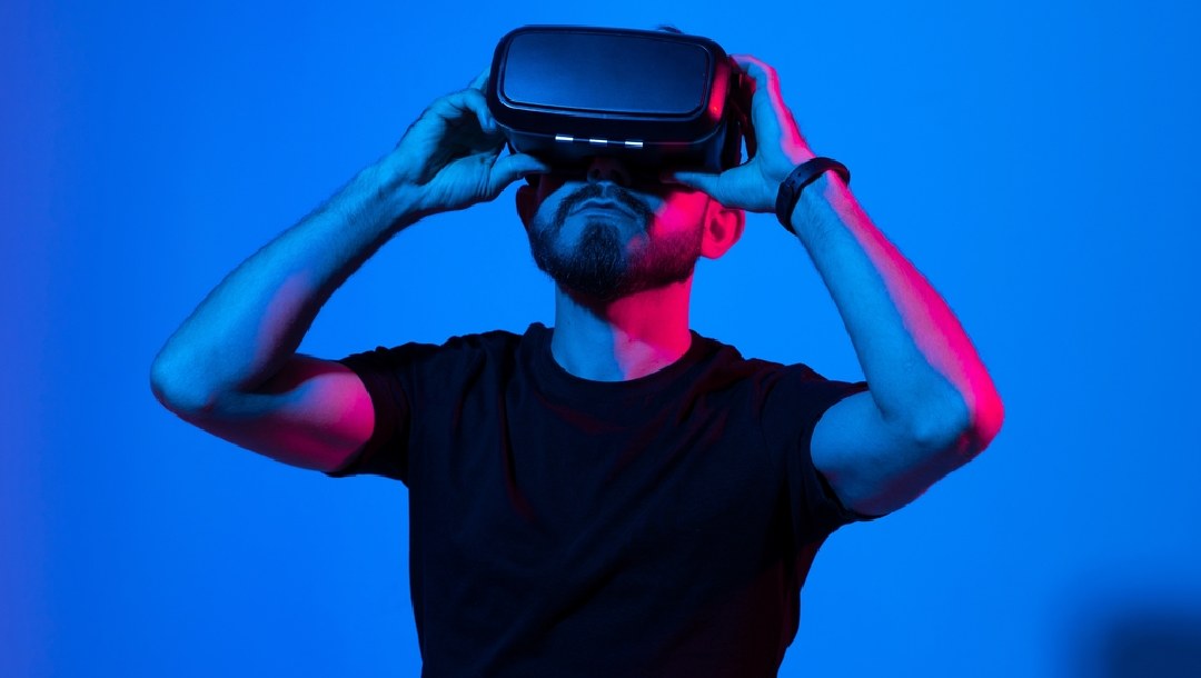 A person wearing a VR headset in a blue room.