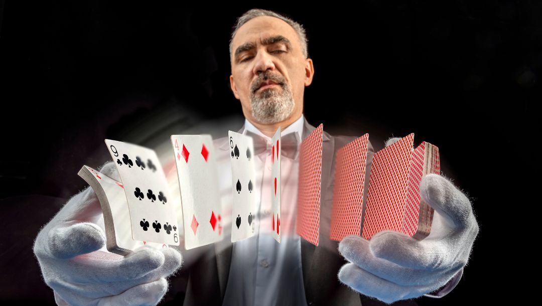 a man wearing white gloves shuffling cards in front of him