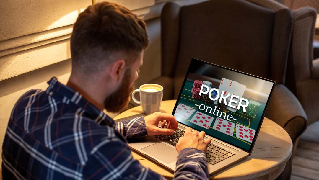 A man playing online poker on a laptop