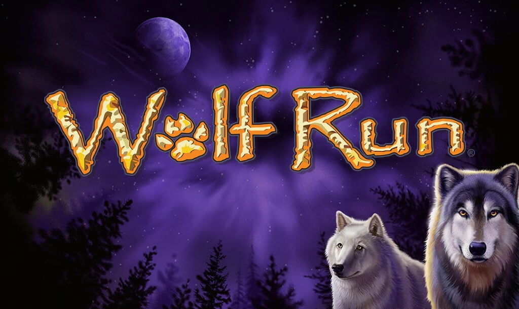 The title screen for the Wolf Run slot game. The game logo appears in the center of the screen in gold lettering with white textured details, and the “O” is a wolf’s paw. Two wolves are in one of the corners of the screen and the background makes it look like the viewer is looking up at the full moon in the night sky, with trees in their peripheral vision.