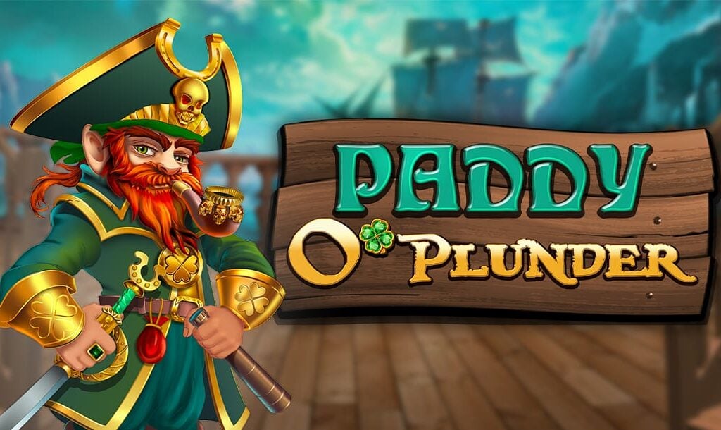 The title screen of Paddy O’ Plunder. The game title appears on a banner made of three wooden planks. A pirate leprechaun stands next to it. In the background, which is slightly blurred, the deck of a pirate ship can be seen as well as another ship in the distance.