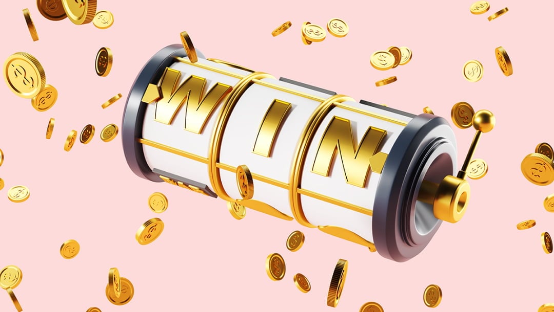 The word “Win” spelled out on a single-row, three-reel slot with a gold lever and black frame. This appears on a pale pink background with gold coins scattered around the image.