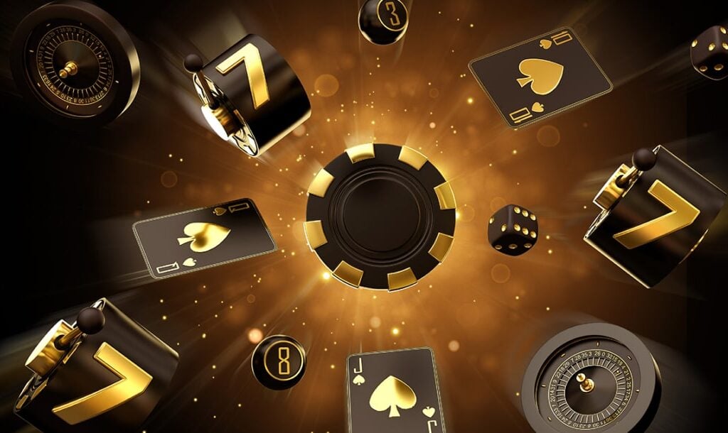 A black and gold poker chip in the center of a casino concept image. Single-row slot reels with 7s on them, playing cards, dice, bingo balls, and a roulette wheel float around the image. There is a golden burst of light in the center of the black background.